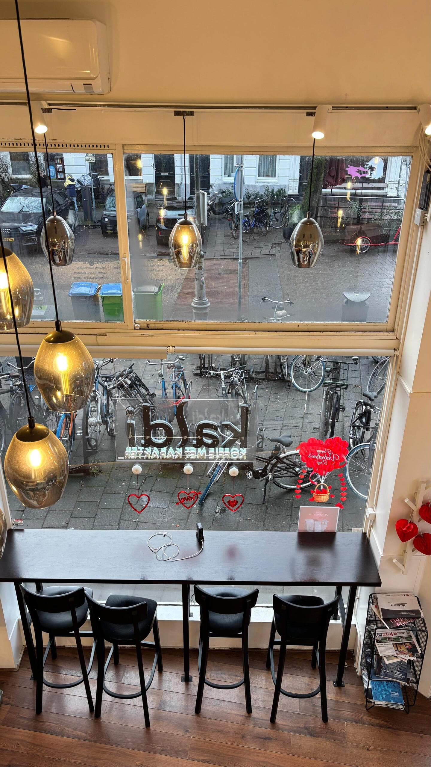 Window bar seating overlooking an Amsterdam street with Valentine's decorations